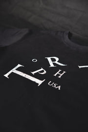 A close-up of a black t-shirt featuring a distressed white graphic print with the letters 'ORPH' and 'USA' on the chest.